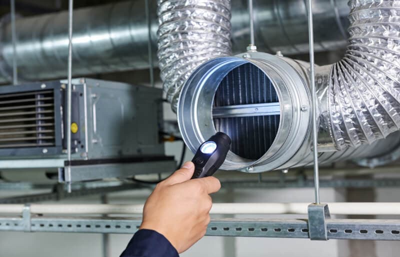 A member of the H2O Hygiene team conducting a ductwork inspection
